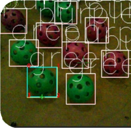 Neural network detections drawn as boxes around purple and green balls