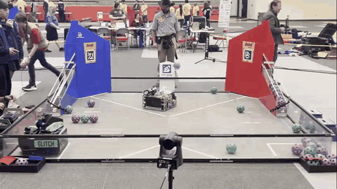 The robot driving across the field while shooting balls into the goal